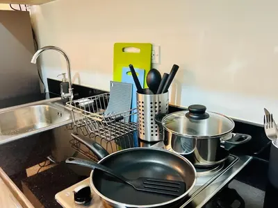 a frying pan on a stove in a kitchen at JR864 House in Manila