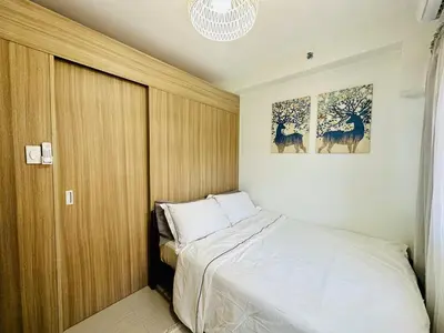 a bedroom with a bed and two pictures on the wall at MK1661 House in Manila