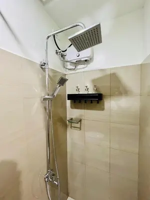 a shower in a bathroom with a sink at TM1410 House in Manila