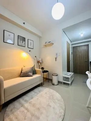 a living room with a couch and a table at TM1410 House in Manila