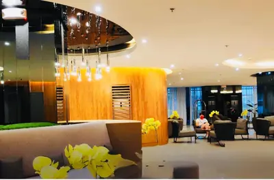a lobby of a hotel with a chandelier at Graceful Getaway Suites in Manila