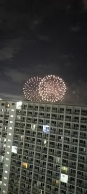 a large building with fireworks in the sky at night at Carps Staycation in Manila
