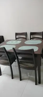 a wooden table with two chairs around it at 1 Bedroom Near Airport Pasay City in Manila