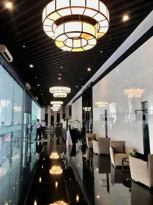 a lobby with chairs and chandeliers in a building at Air Residence Tower B RM 445 Elegant and cosy Makati condoxd in Manila