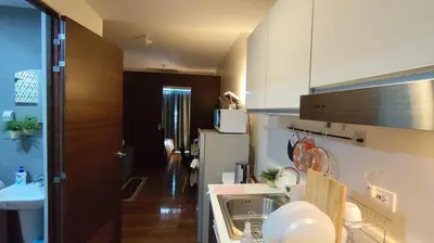 a small kitchen with a sink and a refrigerator at Air Residence Tower B RM 445 Elegant and cosy Makati condoxd in Manila