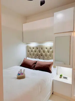 a bedroom with a large white bed with a headboard at Hearth of Ember 4 at Shore 3 Res in Manila