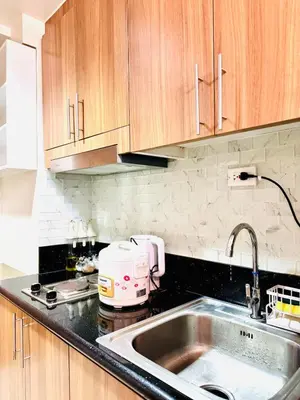 a kitchen with a sink and a toaster on a counter at Hearth of Ember 4 at Shore 3 Res in Manila