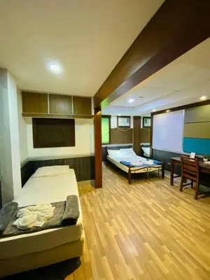 a room with a bed and a projection screen at Casa Verde Hotel & Events Center in Imus
