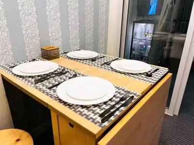 a table with four white plates on top of it at Azure Urban Resort Staycation By Yana in Manila