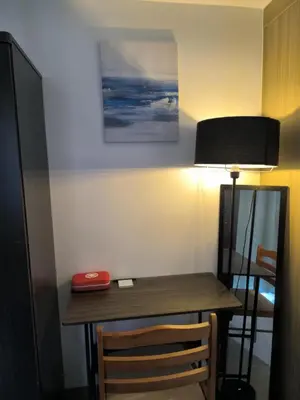 a desk in a room with a lamp and a table at Shore 2 Residences - La Casa in Manila