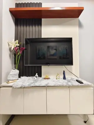 a white cabinet with a tv on top of it at ck staycation coast residence in Manila