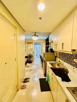 a kitchen with a sink and a counter top at 1Bedroom Pool View - MOA Shell Residences Near Airport in Manila