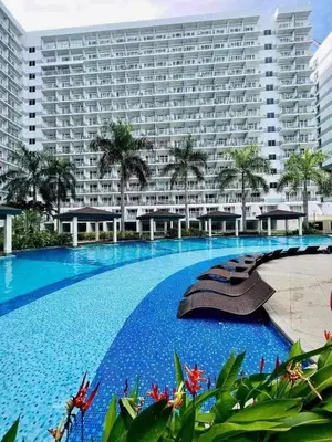 a large apartment building with a large swimming pool at 1Bedroom Pool View - MOA Shell Residences Near Airport in Manila