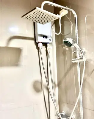 a camera on a tripod in a bathroom at City chic in the heart of Makati #4609 in Manila
