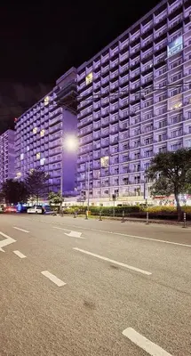 a large building with a parking lot in front of it at SGG Place 2 Bedroom Shell Residences Mall of Asia Near NAIA in Manila