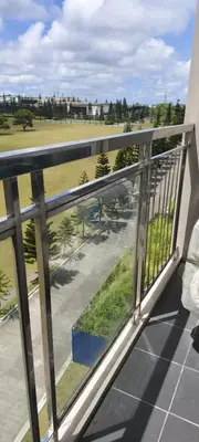 a balcony with a view of a golf course at La Casa Celiacay in Sangley Point Naval Station
