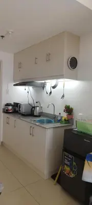 a kitchen with white cabinets and a sink at La Casa Celiacay in Sangley Point Naval Station