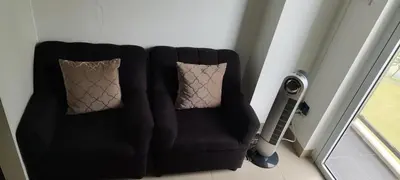a black chair with two pillows in a room at La Casa Celiacay in Sangley Point Naval Station