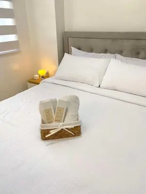 two books in a basket on a bed at The Hive Staycation - SMDC Hope Residences in Trece Martires