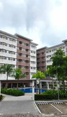 an apartment building with a pool in a parking lot at The Hive Staycation - SMDC Hope Residences in Trece Martires