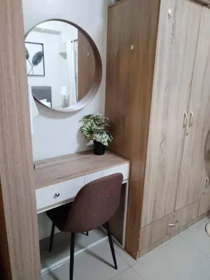 a bathroom with a desk with a mirror and a chair at Shore Residence Tower III in Manila