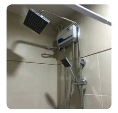 a shower head and a hair dryer on a wall at S-Residence Staycation IKEA,MOA,PICC in Manila