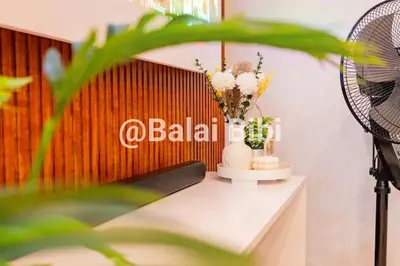 a room with a table with flowers and a fan at Balai Bibi at Urban Deca Homes Ortigas 3Br in Manila