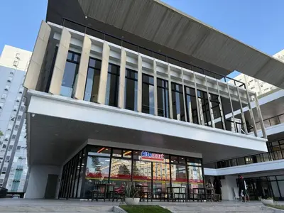 a large building with a store in front of it at Cozy RC 2BR w loft Netflix Prime KTV Games in Manila