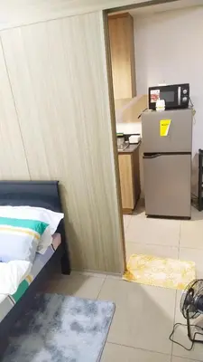 a room with a bed and a refrigerator at 2BR SHORE FAMILY GROUPs AFFORDABLE STAYCATION in Manila