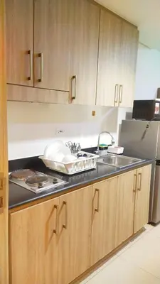 a kitchen with a sink and a refrigerator at 2BR SHORE FAMILY GROUPs AFFORDABLE STAYCATION in Manila