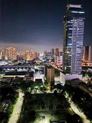 a city skyline at night with tall buildings at Unit 23L T-B The Pearl Place Ortigas in Manila