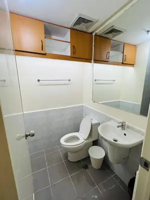 a bathroom with a toilet and a sink at Unit 23L T-B The Pearl Place Ortigas in Manila