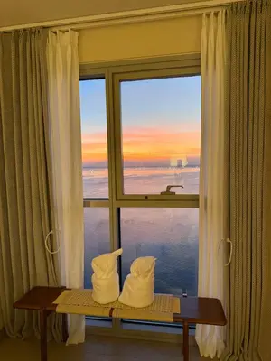 a room with a window with a view of the ocean at Playful 1BR With Magnificant Bayview Garden View Near Okada, Solaire, Aiports in Manila