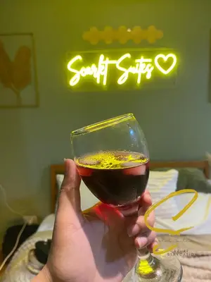 a person holding up a glass of wine at Azure staycation by Scarlet Suites in Manila