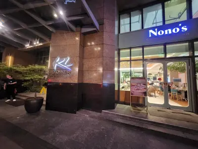 a nomo store with a sign on the side of a building at KL Tower Cosy Studio with City and Park View in Manila