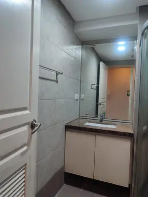 a bathroom with a sink and a mirror at BS651 Room with Balcony and free pool in Manila