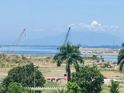a view of a construction site with a palm tree at BS651 Room with Balcony and free pool in Manila