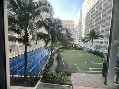 a view of a tennis court from the balcony of a building at 2Br Suite Shore Residences by JMS in Manila