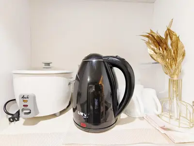 a black tea kettle on a counter with a appliance at Affordable Staycation in Dasma Green 2 Residence in Dasmariñas