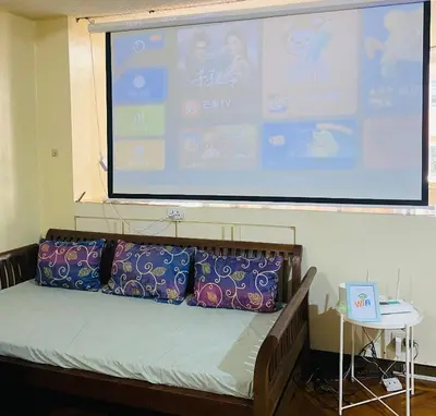 a large projection screen with a bed in a room at He Condotel Bell in Manila