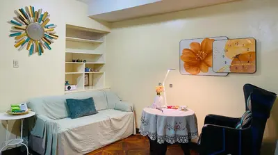 a living room with a couch and a table at He Condotel Bell in Manila