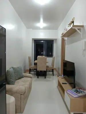 a living room with a couch and a table at Condo Next Door PH in Manila
