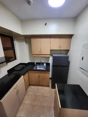 a small kitchen with a sink and a refrigerator at 2BR Condo near BGC in Manila