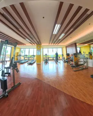 a gym with treadmills and exercise equipment in a building at 1BR Grand Riviera Suites by MrSayla in Manila