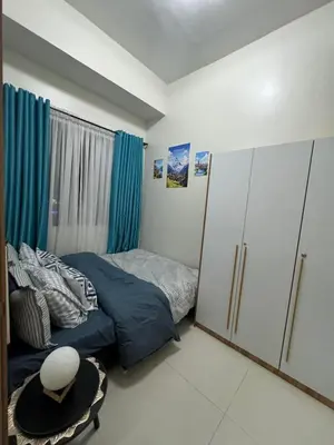 a small bedroom with a bed and a closet at Clarquin Residences - Shore 3 Residences Tower 2 in Manila
