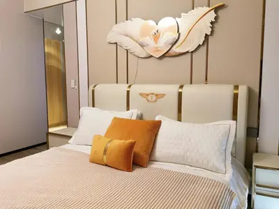 a bedroom with a bed with pillows and a mirror at Bayshore Staycation in Manila