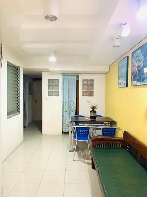 a room with a ping pong table and chairs at He Condotel Blessed in Manila