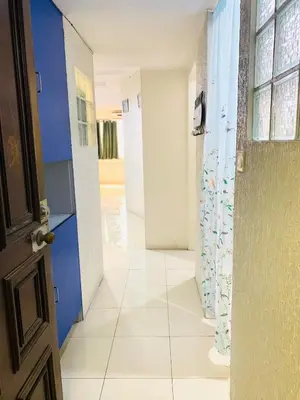 a hallway with blue and white walls and a door at He Condotel Blessed in Manila