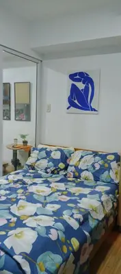 a bedroom with a bed with a blue comforter at Quick Stay PH in Manila