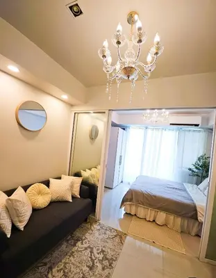 a bedroom with a bed and a chandelier at Quick Stay PH in Manila
